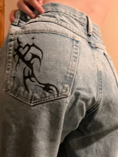 the back of a person's jeans showing their tattoo