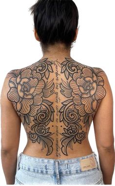 the back of a woman's body with tattoos on it