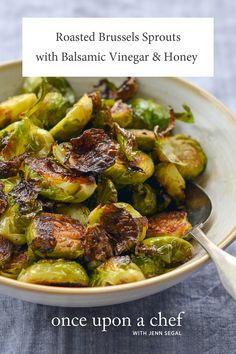 a bowl filled with brussel sprouts on top of a blue table cloth