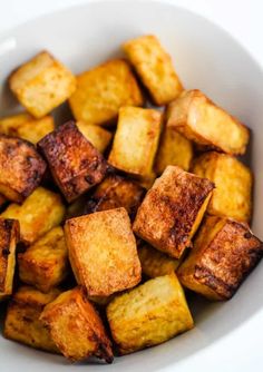 a white bowl filled with cooked cubed potatoes