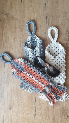 an assortment of purses and sunglasses on a wooden floor