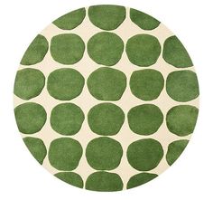 a green and white rug with circles on it