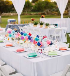 the tables are set with colorful napkins and place settings