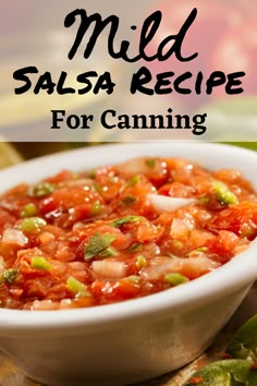 a white bowl filled with salsa sitting on top of a table