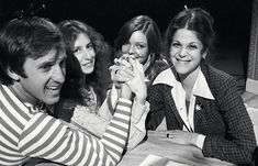 four people sitting at a table eating food