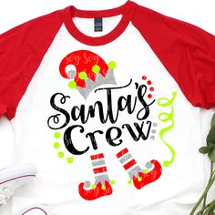 a red and white shirt that says santa's crew with snow boots on it