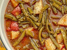 a pot filled with green beans and potatoes