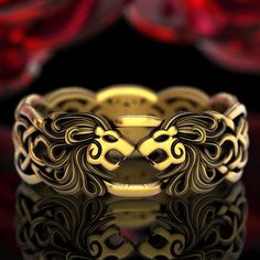 "With two snarling Lion heads, this unique ring embodies the strength and majesty of one of nature's most beautiful felines. Known as the \"King of Beasts,\" the Lion has prominently influenced human art and culture for millennia with their distinct appearance. Holding the dual symbolism of ferocity and protection, these creatures can represent of the often complex nature of familial relationships. With intricate manes flowing into infinity knotwork, this bold design suggests a passionate, forev Lion Ring Gold, Celtic Lion, Mens Celtic Wedding Bands, Celtic Knotwork Design, Ring Cat, Infinity Knot Ring, Celtic Wedding Bands, Lion Jewelry, King Ring