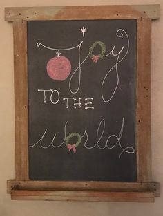 a chalkboard with the words joy to the world written on it