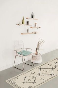 a rug with flowers on it next to a chair