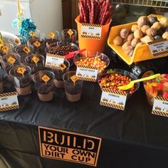 a table topped with lots of cupcakes and candy