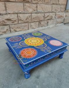 a blue coffee table with colorful designs on it