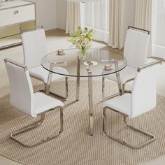 a glass table with white chairs around it