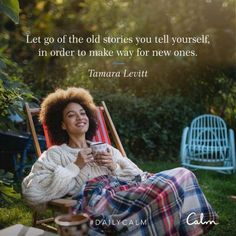 a woman sitting in a lawn chair holding a cup