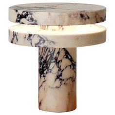 a white and black marble table with two sections on each side, one section is turned upside down