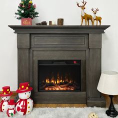 an electric fireplace with christmas decorations on the mantle