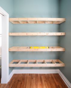 the empty room has wooden shelves in it