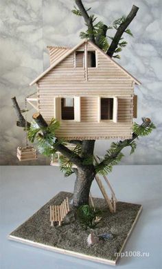 a house built into the side of a tree in front of a wall with clouds