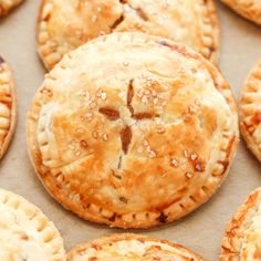 freshly baked pies are arranged in rows on a baking sheet, ready to be eaten