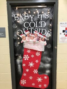 a door decorated with christmas stockings and baby it's cold outside