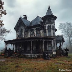 an old victorian style house in the middle of a foggy field with pumpkins on the ground