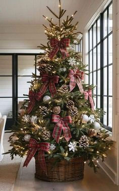 a decorated christmas tree in a basket on the floor