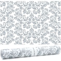 a roll of wallpaper with an ornate pattern on it and a rolled up roller