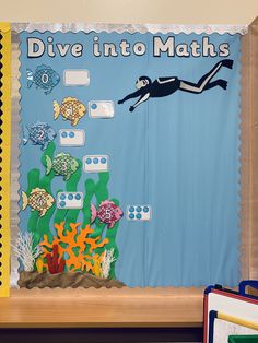 a bulletin board with an image of a diver in the water and fish on it