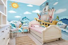 a child's bedroom with a pirate ship mural on the wall