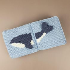 a crocheted blanket with an orca whale on it