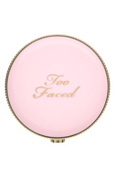 a pink compact mirror with the words too faced on it