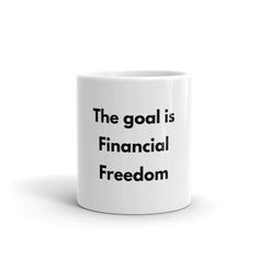 a white coffee mug with the words'the goal is financial freedom'on it