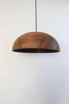 a wooden light fixture hanging from a ceiling