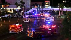 emergency vehicles are parked on the street in front of an intersection at night with palm trees