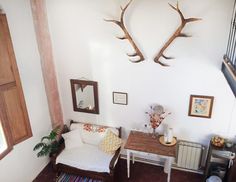 a living room with antlers mounted to the wall