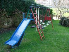 a blue and red play set in the grass