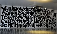 a large black and white wall with words on it