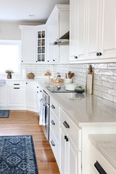 the kitchen is clean and ready for us to use it's white cabinetry