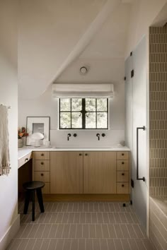 a bathroom with a large window and tiled floor