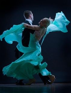 a man and woman dance together in the dark