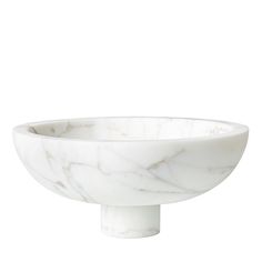 a white marble bowl sitting on top of a table