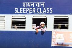 a woman leaning out the window of a train