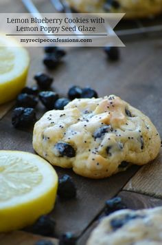 lemon blueberry cookies with lemon poppy seed glaze on a cutting board next to sliced lemons