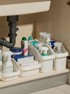 the sink is filled with cleaning products and toiletries