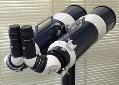 a telescope mounted to the side of a building