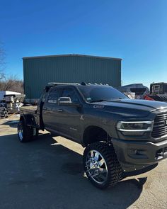 a large black truck parked in front of a building