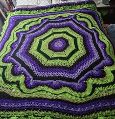 there is a crocheted blanket that looks like it has been made with yarn