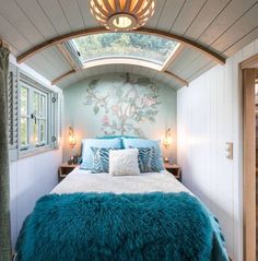 a bed sitting inside of a bedroom on top of a wooden floor next to a window