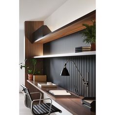 an office with black and white striped walls, wooden shelves and a chair in the foreground