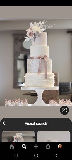 a white wedding cake sitting on top of a table